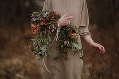 A boho spring bridal bouquet of April flowers in a moody color palette by Nectar and Root, Vermont wedding florist in Burlington, Vermont.