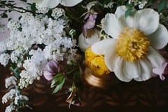 Yellow, pink and white centerpiece by Nectar and Root, Vermont wedding florist at Shelburne Coach Barn in Shelburne, Vermont.
