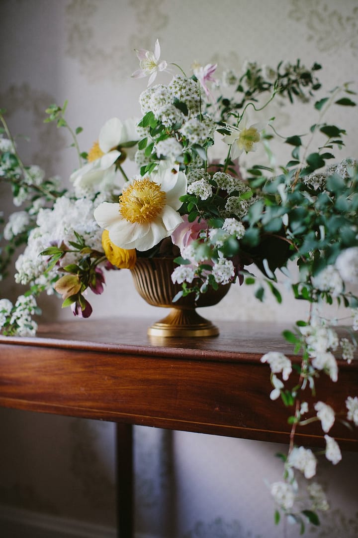 Yellow, green and white centerpiece by Nectar and Root, Vermont wedding florist at Shelburne Coach Barn in Shelburne, Vermont.