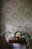 Floral arrangement in room with wallpaper by Nectar and Root, Vermont wedding florist at Shelburne Coach Barn in Shelburne, Vermont.