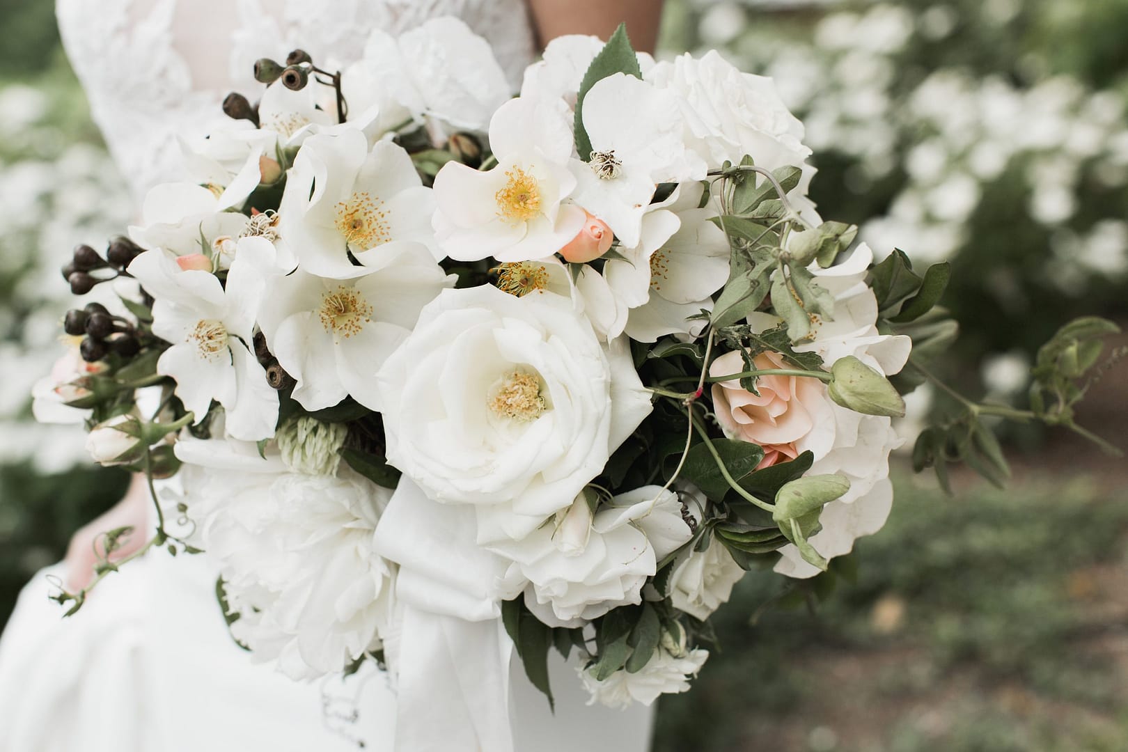 Spring green, peach and white bridal bouquet by Nectar and Root, Vermont wedding florist at Shelburne Museum in Shelburne, Vermont.