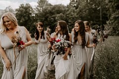 Boho summer bridesmaids bouquets of peonies, roses, tulips, and other June summer flowers in dusty neutral colors for outdoor micro wedding by Nectar and Root, Vermont wedding florist at a backyard wedding in Vermont.