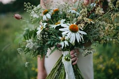 A boho summer wildflower bridal bouquet of August echinacea flowers in a rust and white color palette by Nectar and Root, Vermont wedding florist.