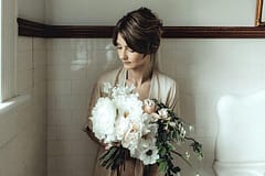 A romantic spring bridal bouquet of May peonies, anemones, garden roses and sweet peas in a blush and white palette by Nectar and Root, a Vermont wedding florist.